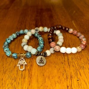 A set of 3 hippie beaded bracelets with charms.